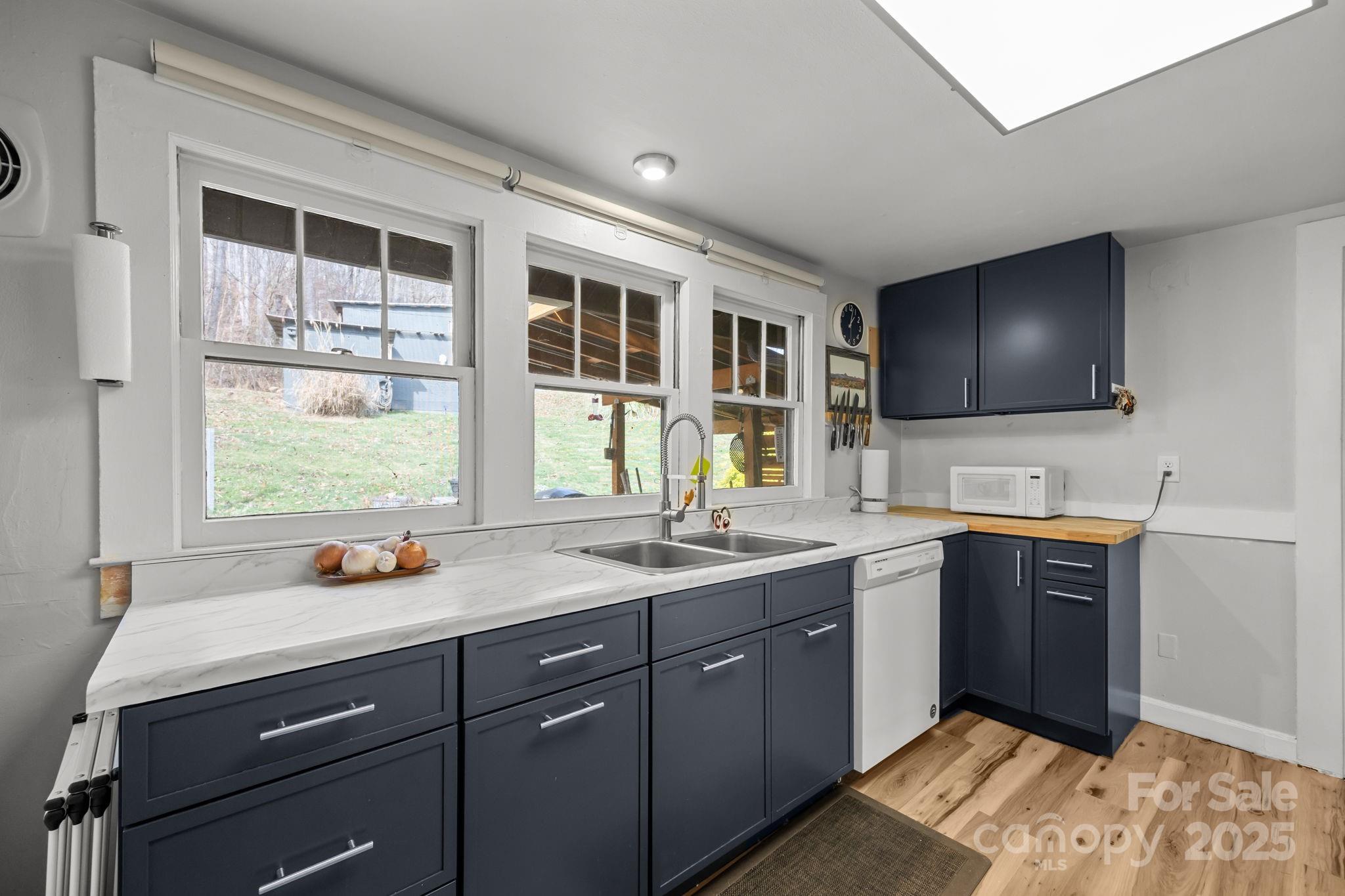 731 Don Felmet Road Marshall, NC 28753 - Photo 10 of 23 a kitchen with a sink stove and cabinets