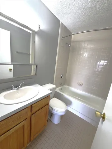 a bathroom with a double vanity sink toilet mirror and shower