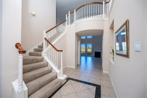 a view of staircase with white walls and a potted plant
