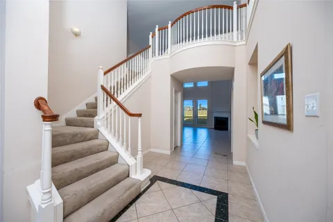 a view of staircase with white walls and a potted plant
