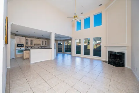 a view of a livingroom with furniture ceiling fan and window