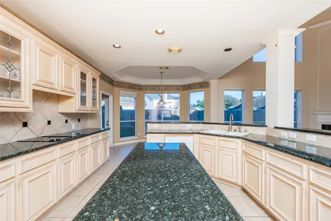 a kitchen with a refrigerator and a stove