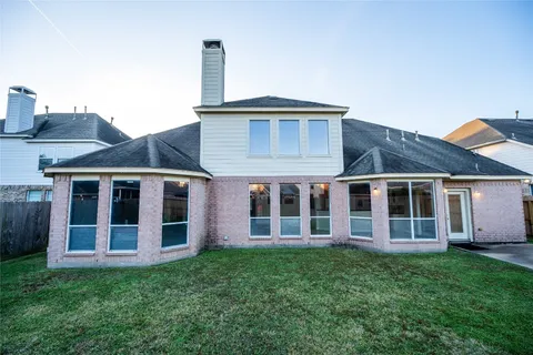 a view of a house with a yard and deck