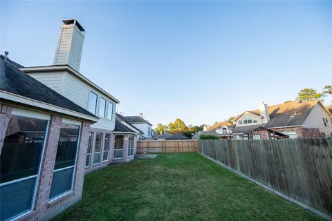 a view of a house with backyard and porch