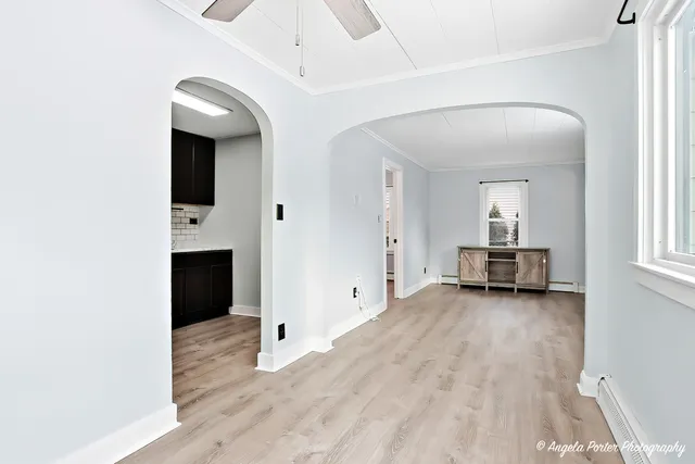 a view of a livingroom with wooden floor and staircase