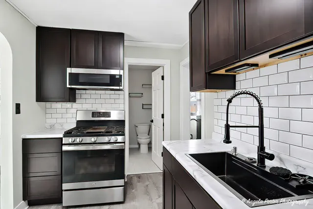 a kitchen with a sink stove and microwave