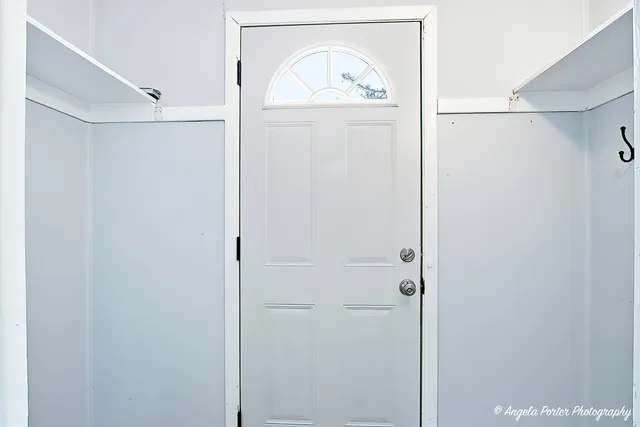 a view of front door with wooden door