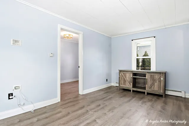 an empty room with a workspace and a window