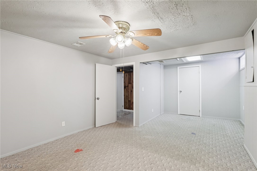 611 Wilson Street Struthers, OH 44471 - Photo 36 of 44 Unfurnished bedroom featuring a textured ceiling, carpet floors, a ceiling fan, and a closet