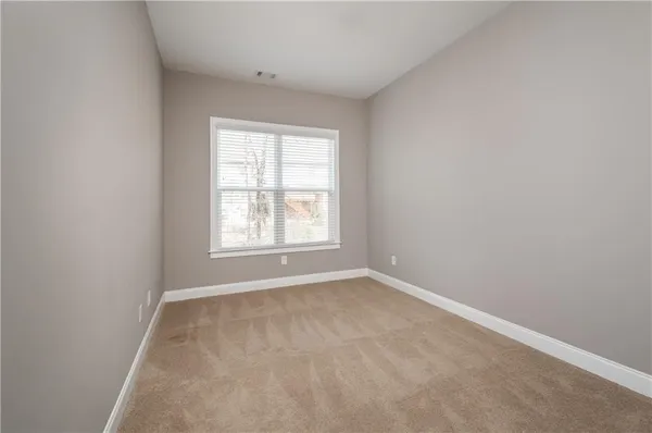 a bathroom with a granite countertop sink a toilet and a mirror