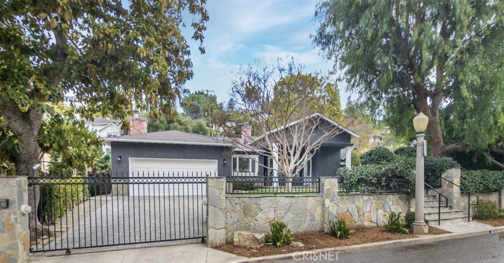 4020 Benedict Canyon Drive Sherman Oaks, CA 91423 - Photo 1 of 1 a front view of a house with a garden