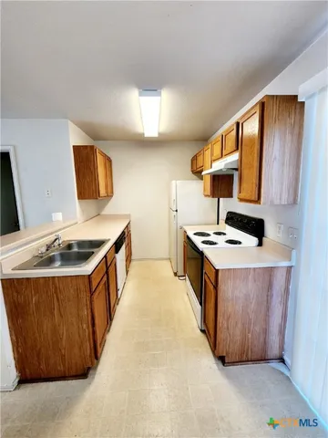 a kitchen with stainless steel appliances granite countertop a stove and a sink