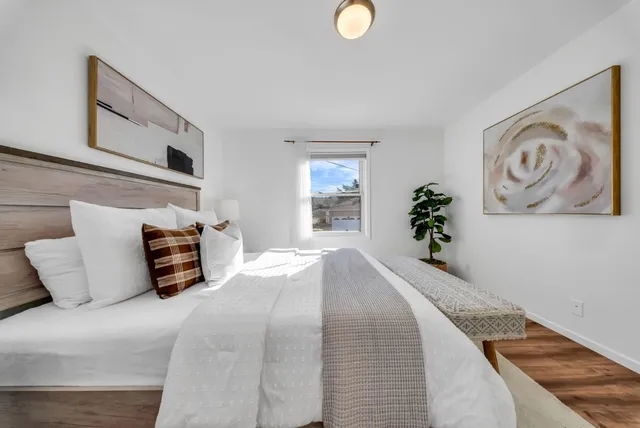 a bedroom with bed and cupboard