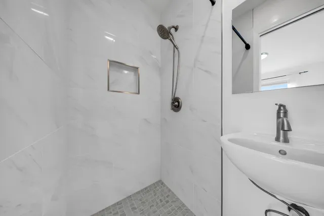 a bathroom with a sink and shower