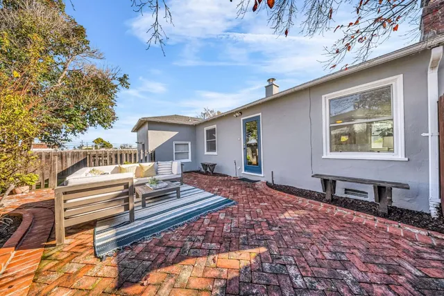 a front view of a house with a wooden bench
