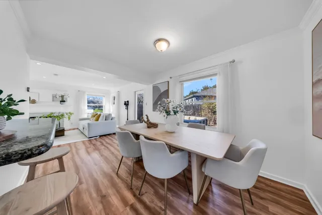 a view of a dining room with furniture window and wooden floor