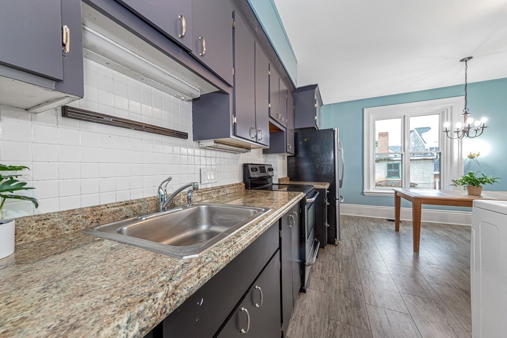 4 Rangeley Road Winchester, MA 01890 - Photo 20 of 42 a kitchen with stainless steel appliances granite countertop a sink a stove and a wooden floors