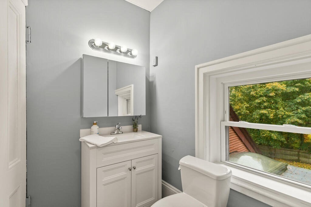 4 Rangeley Road Winchester, MA 01890 - Photo 26 of 42 a bathroom with a granite countertop sink a toilet and a mirror