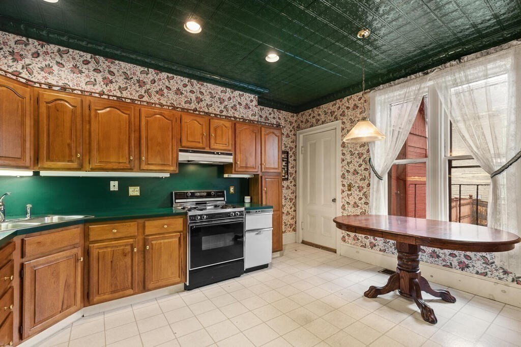 4 Rangeley Road Winchester, MA 01890 - Photo 9 of 42 a kitchen with stainless steel appliances granite countertop a stove a sink dishwasher and cabinets with wooden floor