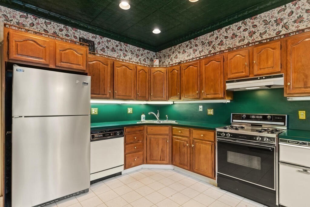 4 Rangeley Road Winchester, MA 01890 - Photo 10 of 42 a kitchen with stainless steel appliances granite countertop a refrigerator a sink and a stove