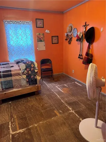 a bedroom with a bed and a mirror