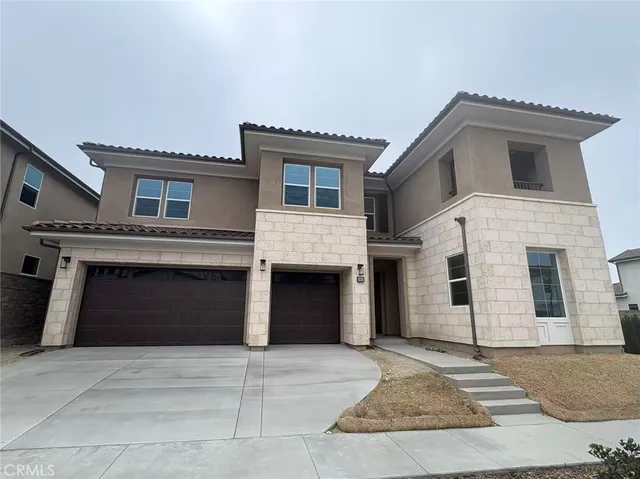 a front view of a house with a garage