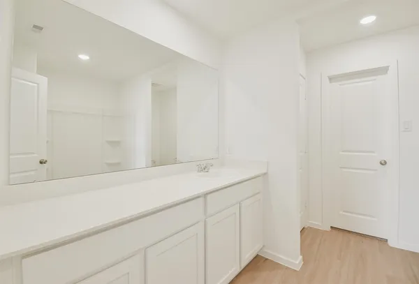 a bathroom with a granite countertop toilet and a shower