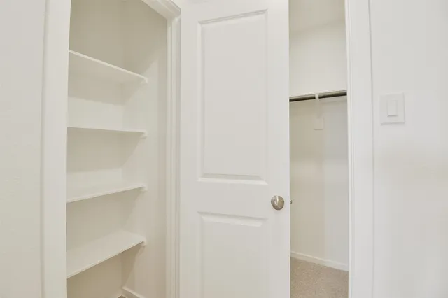 a bathroom with a granite countertop toilet and a shower