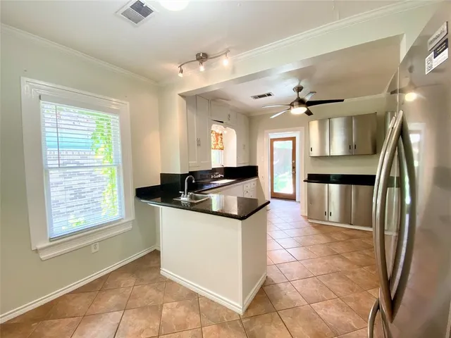 a kitchen with stainless steel appliances granite countertop a stove and a refrigerator