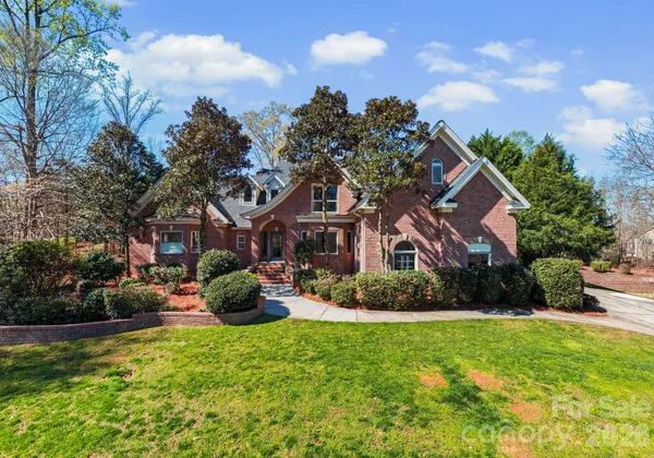 a front view of a house with a garden and plants