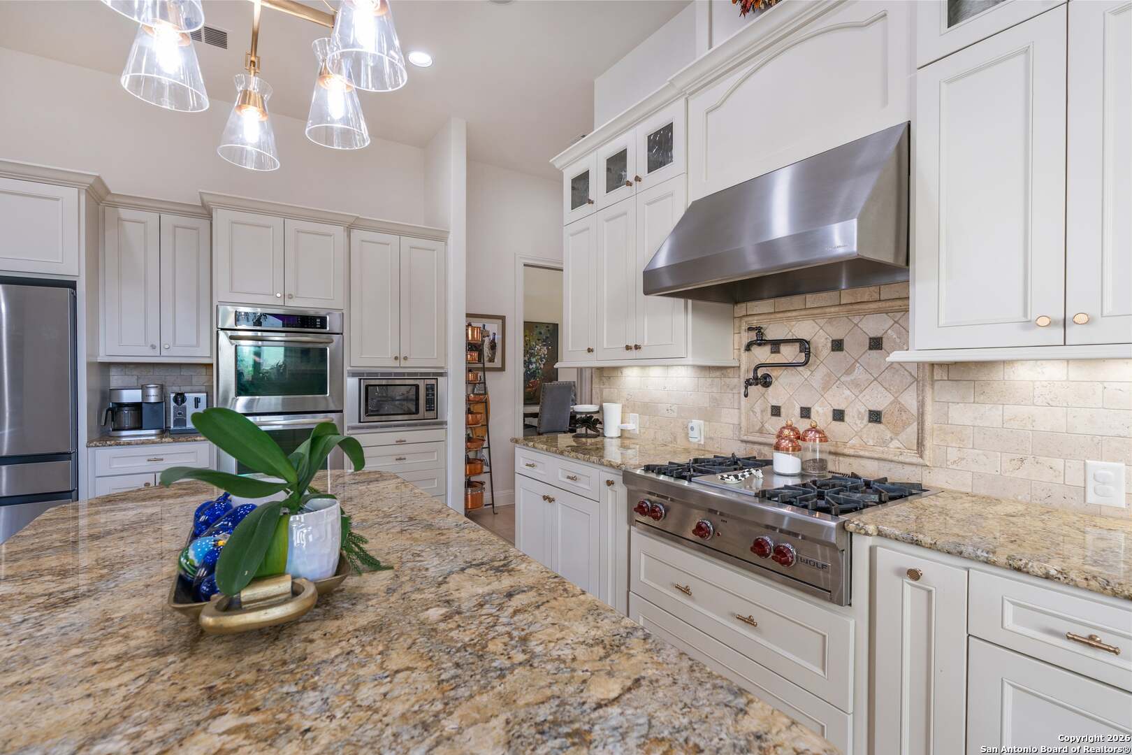 101 River Crossing Boerne, TX 78006 - Photo 27 of 65 a kitchen with a stove a microwave and a refrigerator