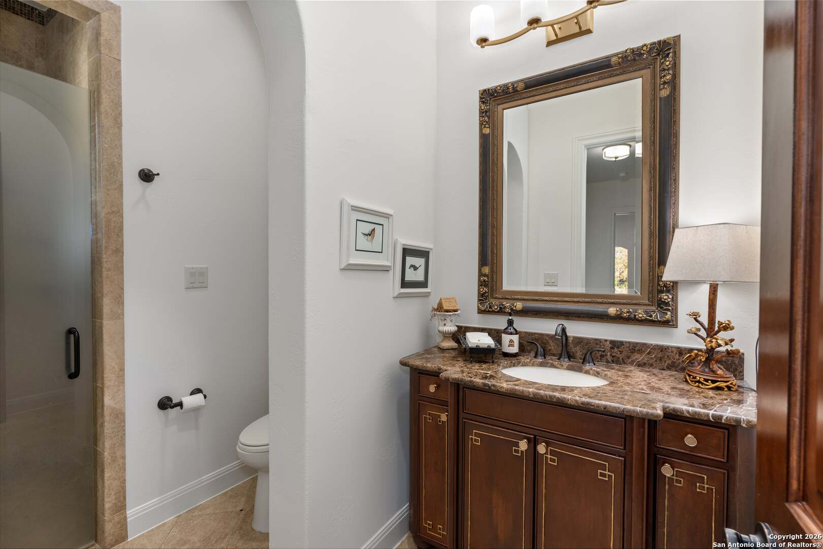 101 River Crossing Boerne, TX 78006 - Photo 32 of 65 a bathroom with a granite countertop sink toilet and mirror
