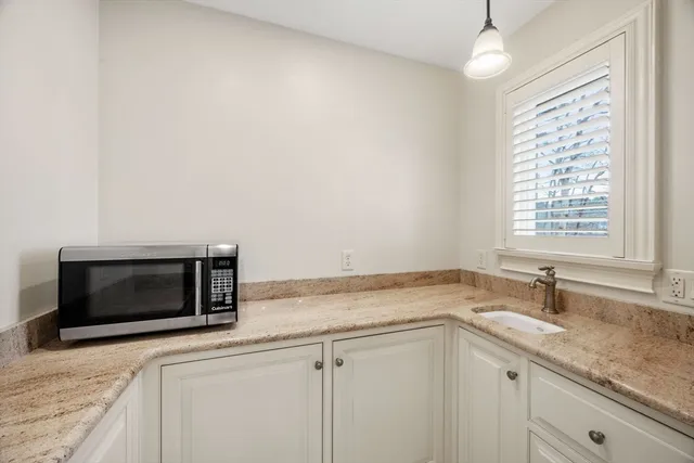 a kitchen with a sink and a microwave