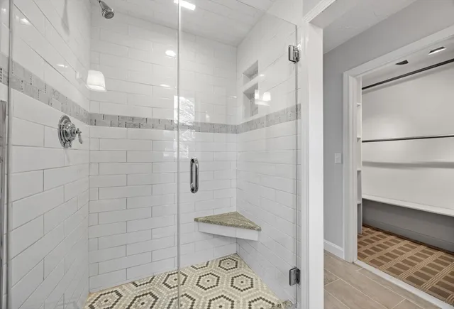 a bathroom with a shower and toilet