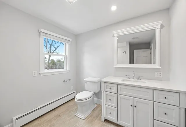 a spacious bathroom with a toilet sink and mirror