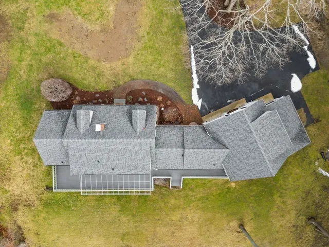 an aerial view of a house with a swimming pool