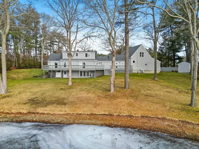 a view of a house with swimming pool and sitting area