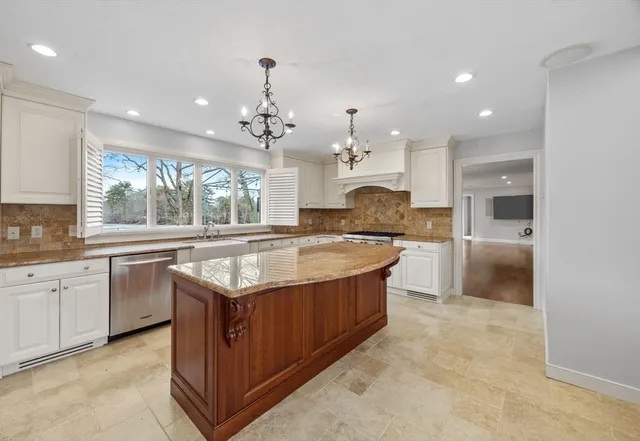 a large kitchen with kitchen island granite countertop a large counter top and sink