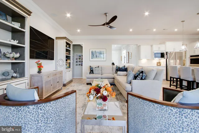 a kitchen with stainless steel appliances a sink a refrigerator and cabinets