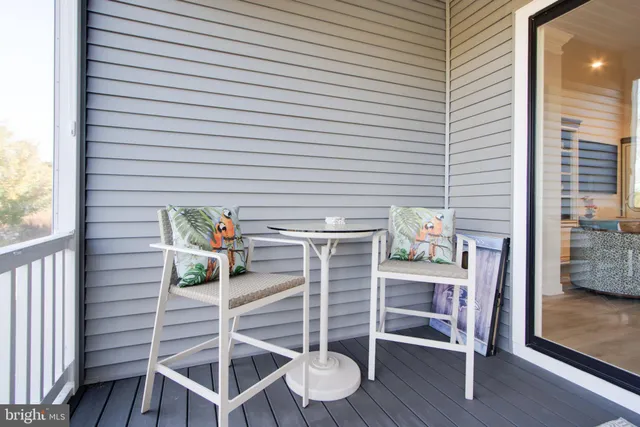 a living room with furniture a rug and a window
