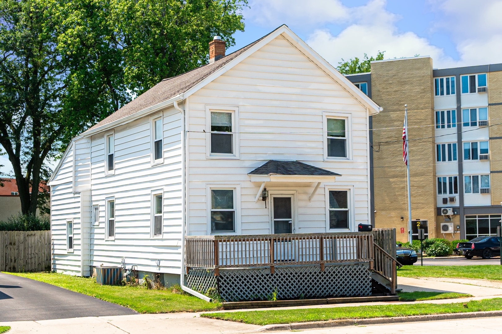 344 Grant Street Sycamore, IL 60178 - Photo 28 of 29 a view of a white house with large windows and a yard