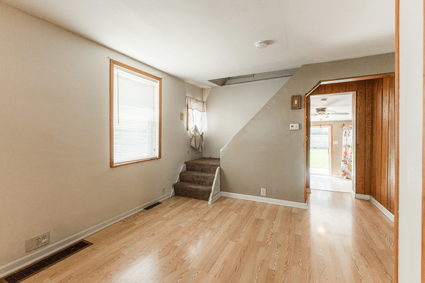 344 Grant Street Sycamore, IL 60178 - Photo 3 of 29 an empty room with wooden floor and windows