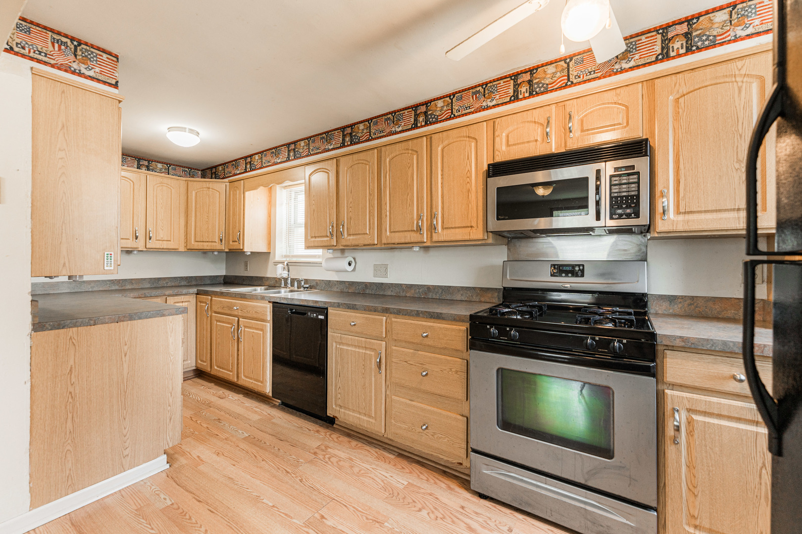344 Grant Street Sycamore, IL 60178 - Photo 4 of 29 a kitchen with stainless steel appliances a stove sink microwave and cabinets
