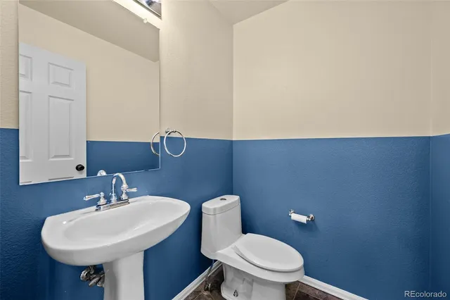 a bathroom with a sink a mirror and a toilet