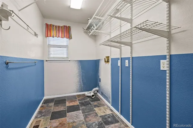a view of a room with a ceiling fan and window