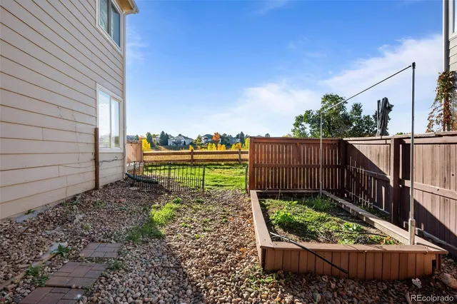a view of a backyard with wooden fence