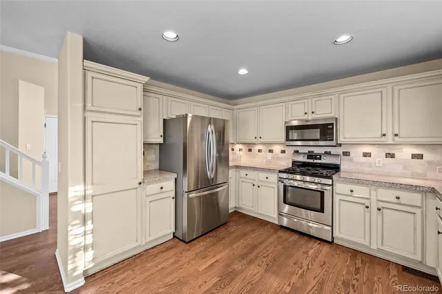 a kitchen with stainless steel appliances a refrigerator sink and microwave