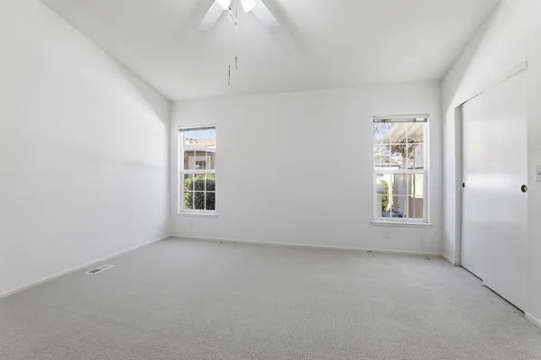 an empty room with a empty space and windows