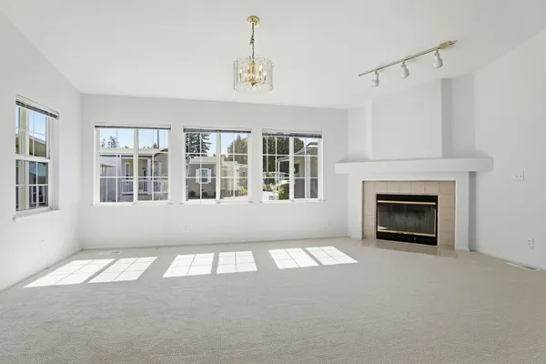 a big room with windows and a fireplace