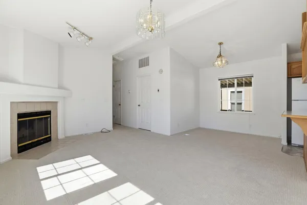 a view of an empty room with windows